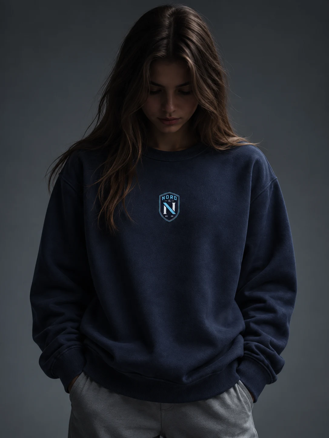 Model in a navy Nord IL sweatshirt with the club crest on the chest