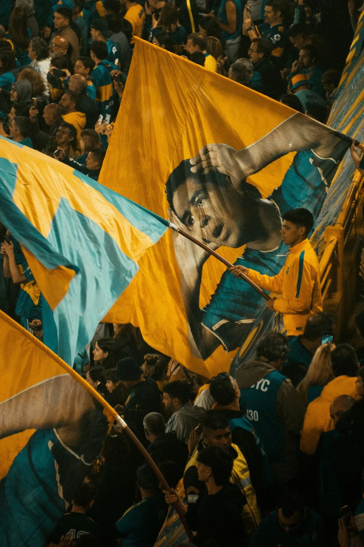Large supporter flags being waved in the stands