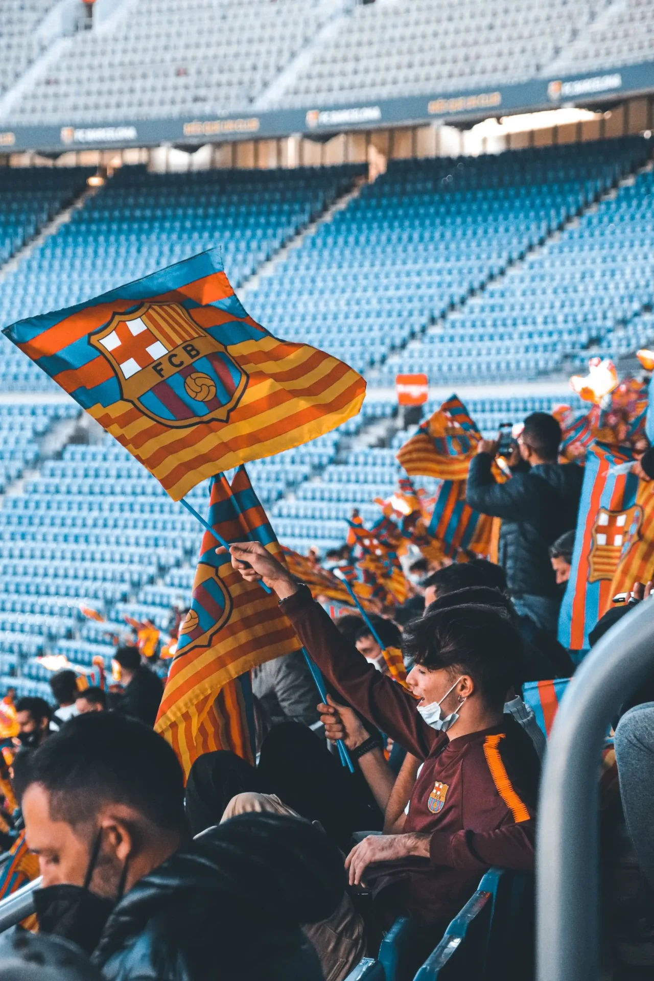 Supporter with a club flag at the stadium